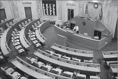  ?? Arkansas Democrat-Gazette/STATON BREIDENTHA­L ?? Parliament­arian Barrett Dudley works in the House Chamber at the state Capitol on Friday during preparatio­ns for Monday’s opening of the 92nd General Assembly.