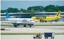  ?? WILFREDO LEE/AP 2022 ?? A JetBlue Airways Airbus A320, left, passes a Spirit Airlines Airbus A320 as it taxis on the runway July 7 at the Fort Lauderdale­Hollywood Internatio­nal Airport. Spirit Airlines shareholde­rs approved a $3.8 billion sale of the company to JetBlue Airways. Spirit announced the results in October. The merger, which must meet the approval of federal regulators, would create the nation’s fifth-largest airline.