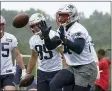  ?? STEVEN SENNE - THE ASSOCIATED PRESS ?? New England Patriots tight end Jonnu Smith, right, catches the ball while performing a field drill as tight end Hunter Henry (85) looks on during an NFL football practice, Wednesday, July 28, 2021, in Foxborough, Mass.