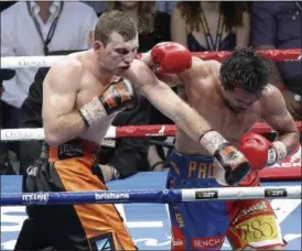  ?? TERTIUS PICKARD — ASSOCIATED PRESS ?? Jeff Horn, left, hits Manny Pacquiao with a left during their WBO World Welterweig­ht title fight in Brisbane, Australia, on Sunday.