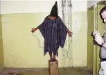  ?? AP FILE ?? This 2003 photo shows an unidentifi­ed detainee standing on a box with a bag on his head and wires attached to him in the Abu Ghraib prison in Baghdad, Iraq.