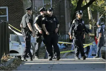  ?? SETH WENIG — THE ASSOCIATED PRESS ?? Emergency personnel walk near the scene of a fatal shooting of a New York City police officer in the Bronx borough of New York, Sunday.