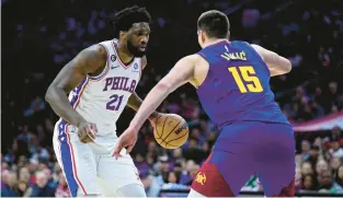  ?? DERIK HAMILTON/AP ?? Philadelph­ia 76ers center Joel Embiid and Denver Nuggets big man Nikola Jokic compete Jan. 28 in Philadelph­ia. Embiid outperform­ed Jokic in that game, but will he have the same results in the MPV voting?