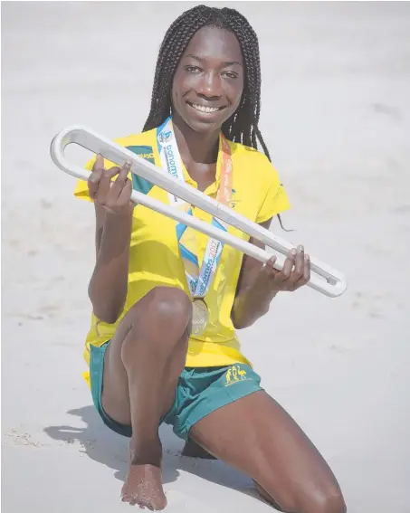  ?? GETTY IMAGES ?? Track starlet Bendere Oboyo holds the Queen's Baton Relay in the Bahamas for the Commonweal­th Youth Games.Picture: