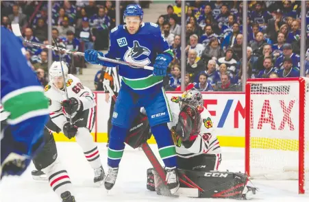  ?? ARLEN REDEKOP/ FILES ?? Justin Bailey was called up last year and appeared in two games. Here, he jumps up in front of Chicago Blackhawks goalie Corey Crawford at Rogers Arena during a game last Feb. 12. General manager Jim Benning says Bailey did well at training camp in July.