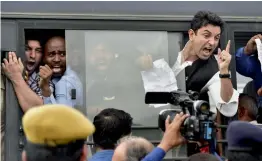  ?? — PTI ?? Policemen detain protesters in New Delhi on Saturday during their march near Vijay Chowk to hand over a memorandum to the NHRC over the recent deaths at a Gorakhpur Hospital.