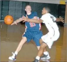  ?? Photo by Steve Sherman ?? Holy Ghost junior Matt England (L) looks to dish off in the Firebirds’ dramatic last-second win over Glen Mills in the tipoff tourney opener.