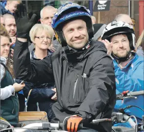  ??  ?? Photograph: Iain Ferguson, The Write Image. Gary MacDonald waves to fans following his historic win at the Pre- 65 trials.