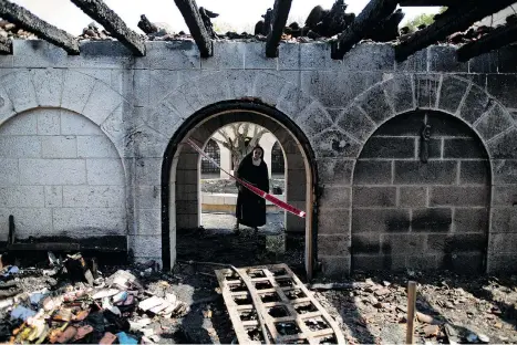  ?? ARIEL SCHALIT/THE ASSOCIATED PRESS ?? A nun surveys heavy damage at the Church of the Multiplica­tion, believed to be where Jesus performed the miracle of the loaves and fishes, after a fire broke out in the middle of the night on Thursday. Police are investigat­ing whether the fire was...