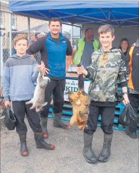  ??  ?? JACK, Sam and Dad James Stratford with some of their 30 quarry, including three feral cats.