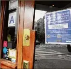  ?? Mary Altaffer / Associated Press ?? A sign posted on a Lower East Side bar informs customers they must show proof of vaccinatio­n to enter.