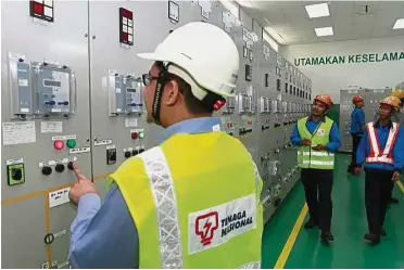  ??  ?? Tariff review: Workers manning a control panel at TNB’s distributi­on sub-station in Bayan Lepas. The base tariff for electricit­y is subject to review every three years.