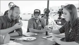  ?? Herald photo by Greg Bobinec ?? Lethbridge Herald City Editor Nick Kuhl and Video Journalist from CTV Lethbridge Alison MacKinnon take their first bite of the cricket filled grilled cheese sandwich for the Fair Food Challenge at Whoop-Up Days, Tuesday afternoon.