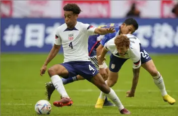  ?? Associated Press ?? Tyler Adams, left, and Joshua Sargent, right, playing during the a friendly soccer match Sept. 23 between the U.S. and Japan as part of the Kirin Challenge Cup in Duesseldor­f, Germany. Adams has been named the United States' captain for the World Cup ahead of their opener against Wales on Monday.