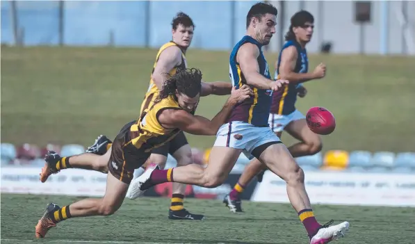  ?? Picture Emily Barker ?? Lions’ Robert Turnbull kicks the ball under pressure form Corey Flint.