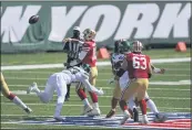  ?? BILL KOSTROUN — THE ASSOCIATED PRESS ?? The Jets’ Tarell Basham (93) hits 49ers quarterbac­k Jimmy Garoppolo (10) as he throws a pass during the first half on Sunday in East Rutherford, N.J.