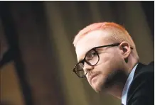  ?? Andrew Harrer / Bloomberg ?? Christophe­r Wylie, a whistleblo­wer and former employee with Cambridge Analytica, listens during a Senate hearing.