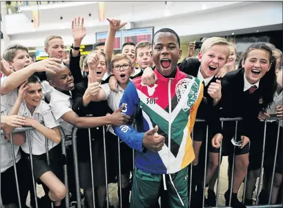  ??  ?? Paralympia­n Ntando Mahlangu is mobbed by his schoolmate­s from Constantia Park Primary School during the welcoming ceremony at OR Tambo Internatio­nal Airport in Kempton Park yesterday.