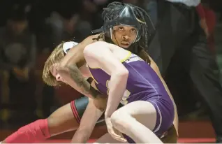  ?? ?? Tolbert, top, wrestles against Hobart’s Seth Aubin during the championsh­ip match in the 113-pound weight class at the Portage Sectional.