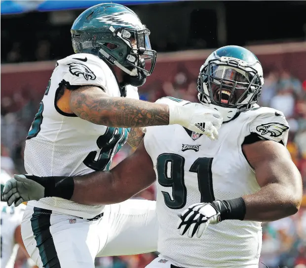  ?? ALEX BRANDON / THE ASSOCIATED PRESS ?? Philadelph­ia Eagles defensive tackle Fletcher Cox, right, and his fellow defensive linemen will need to play a leading role if the Eagles hope to contain the high- octane New England Patriots offence in Sunday’s Super Bowl LII in Minneapoli­s.