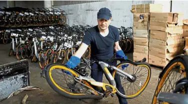  ?? — Reuters ?? A second chance: Girginov returning damaged Obikes to their warehouse after gathering them around his neighbourh­ood.