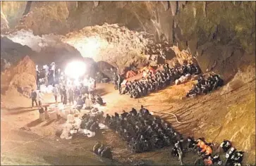  ?? Tassanee Vejpongsa Associated Press ?? RESCUERS working in a cave in northern Thailand to find 12 missing soccer players, ages 11 to 16, and their coach have to contend with darkness, poor ventilatio­n and muddy waters that rose to almost 23 feet.