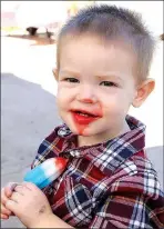  ?? COURTESY PHOTO ?? Reece Pierson enjoys a popsicle during Jane Days last year. Organizers are adding more children’s games to the festival this year.