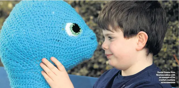  ?? JUSTIN KERNOGHAN ?? Daniel Simms from Newtownabb­ey with an example of his crochet creations