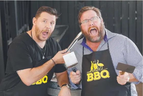  ?? Picture: AAP IMAGE ?? Manu Feildel and Shane Jacobson cook up publicity for their new Australian comedy film, The BBQ.