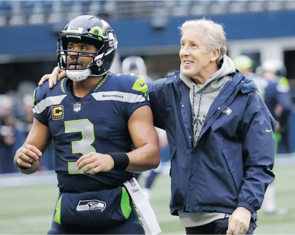  ?? THE ASSOCIATED PRESS ?? Russell Wilson will join the rare fraternity of quarterbac­ks leading their team in rushing for a season, but is still second in the NFL with 32 touchdown passes.