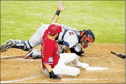  ??  ?? Houston Astros catcher Martin Maldonado (back), is unable to get the tag on Texas Rangers’ Isiah Kiner-Falefa who scored on a fielder’s choice hit by Joey Gallo in the 10th inning
of a baseball game in Arlington, Texas on Sept 25. (AP)
