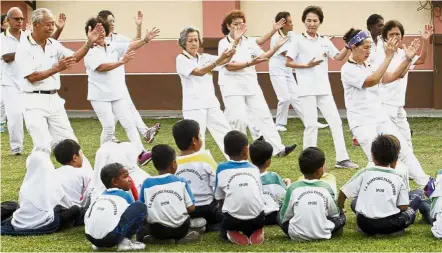  ??  ?? You’re never too young to learn tai chi, which is a good example of a flexibilit­y exercise that can help prevent injury as one ages.