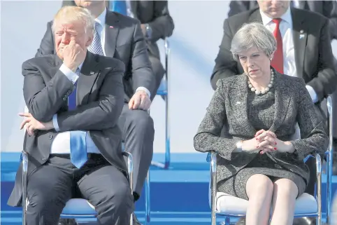  ?? REUTERS ?? US President Donald Trump, left, and Britain’s Prime Minister Theresa May, right, during a ceremony at the new Nato headquarte­rs before the start of a summit in Brussels last year.