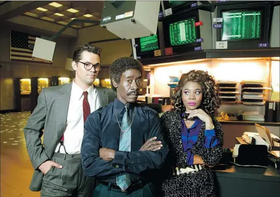  ?? Kirk McKoy Los Angeles Times ?? BLAIR (Andrew Rannells), left, gets manipulate­d by Mo (Don Cheadle) and Dawn (Regina Hall), his bosses at the rebellious investment firm the Jammer Group.