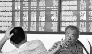  ?? QI WEN / FOR CHINA DAILY ?? Investors talk about stocks in a securities trading center on Tuesday in Fuyang, a city in eastern China’s Anhui province.