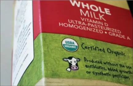  ?? STEVEN SENNE — THE ASSOCIATED PRESS ?? A “USDA Organic” label is printed on a milk carton in Walpole, Mass. The USDA Organic label generally signifies a product is made without synthetic pesticides and fertilizer­s, and that animals are raised according to certain standards. But disputes over the rules and reports of fraud may have some questionin­g whether the seal is worth the price.