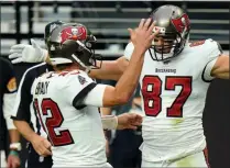  ?? JEFF BOTTARI - THE ASSOCAITED PRESS ?? FILE - In this Oct. 25, 2020, file photo, Tampa Bay Buccaneers tight end Rob Gronkowski (87) celebrates with quarterbac­k Tom Brady (12), left, after scoring a touchdown against the Las Vegas Raiders during the first half of an NFL football game in Las Vegas.