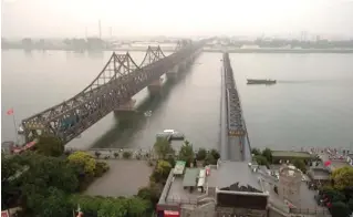  ??  ?? Bridge over the Yalu river near Dandong, which is where most goods cross between the two countries.