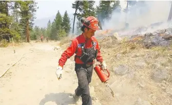  ?? B.C. WILDFIRE SERVICE ?? A B.C. Wildfire Service worker starts a small backfire on the Thomas Creek wildfire. There were 245 wildfires in the province on Thursday, with 36 considered extremely threatenin­g or highly visible.