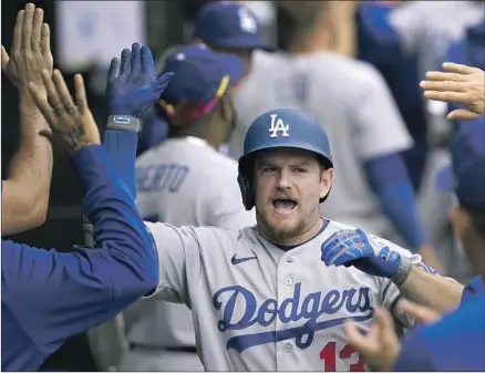  ?? Charles Rex Arbogast Associated Press ?? MAX MUNCY celebrates his three-run home run in the sixth inning. He knocked in five runs for the first time since August.