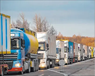  ?? Mindaugas Kulbis The Associated Press ?? Trucks are stuck in traffic jams for 37 miles Tuesday on the Lithuanian side to enter Poland through the Kalvarija-budzisko checkpoint.