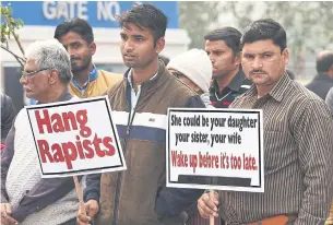  ??  ?? STRONG BELIEFS: Demonstrat­ors hold placards to protest against rape in New Delhi in December.