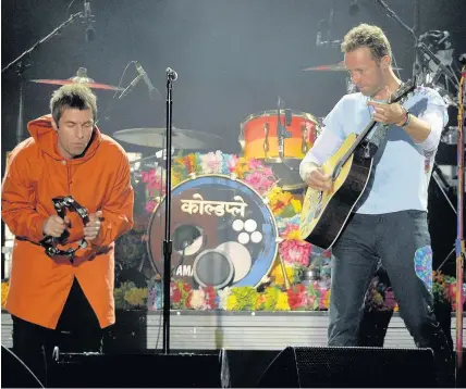  ??  ?? > Chris Martin, right, performs at the One Love Manchester benefit concert with Liam Gallagher