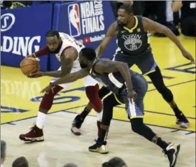  ?? MARCIO JOSE SANCHEZ — ASSOCIATED PRESS ?? LeBron James is defended by Warriors forward Draymond Green, bottom, and forward Kevin Durant during Game 2 of the NBA Finals in Oakland, Calif. on June 3.