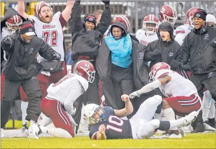  ?? BRAD HORRIGAN | BHORRIGAN@COURANT.COM ?? THE UMASS BENCH erupts in reaction to a game-clinching intercepti­on by Lee Moses, left, as intended receiver Zavier Scott of UConn falls to the turf. At top, UConn coach Randy Edsall can only watch as the Huskies clinched an eighth straight losing season, falling to the Minutemen on Saturday.