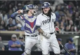  ?? Denis Poroy Getty Images ?? FREDDY GALVIS of the Padres is unhappy after striking out in the eighth inning against reliever Dylan Floro, who retired all three batters he faced.