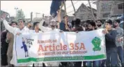  ?? AFP ?? Protestors shout slogans against revoking article 35A and 370.