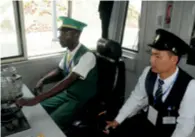  ??  ?? A trainee Kenyan driver is monitored by his Chinese instructor