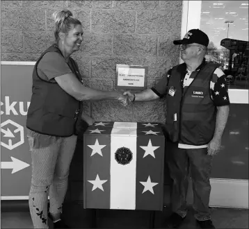  ??  ?? LOWE’S STORE MANAGER Janet Wheeler (left) and customer service associate Walt Blakesley with a box built by Blakesley where customers can drop off worn or stained American flags for proper disposal by American Legion Post 19. The box was officially placed next to the front door on Friday.