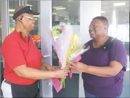  ?? STAFF PHOTOS BY TIFFANY WATSON ?? Spring Dell Center volunteer Rosalie Hawkins gave flowers to Wawa employee Inez Early at the Wawa in White Plains on Oct. 19.